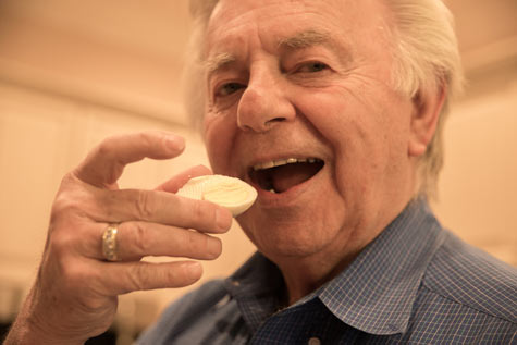 senior man eating a hard-boiled egg