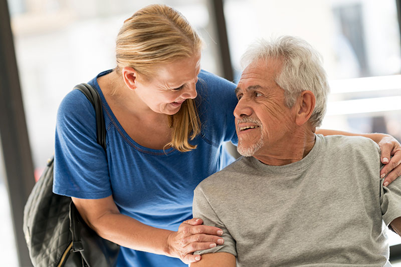 caregiver-comforting-senior-man-with-dementia