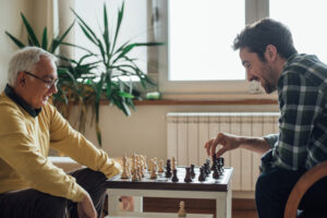 senior-man-and-grandson-playing-chess