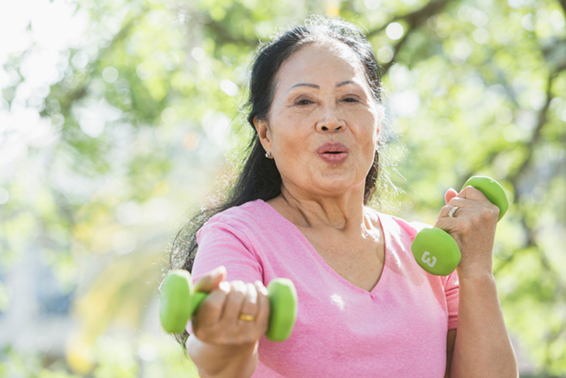 A woman finishes her exercise routine, a necessary step in stroke prevention in older adults.